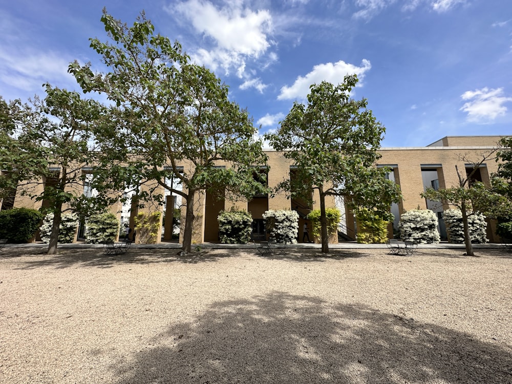 a large building with a lot of trees in front of it