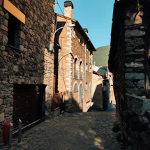 Elegant stone street in an Italian village bathed in warm golden light, hinting at timeless charm.