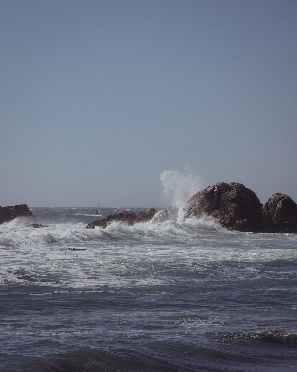 a person riding a surfboard on top of a wave in the ocean