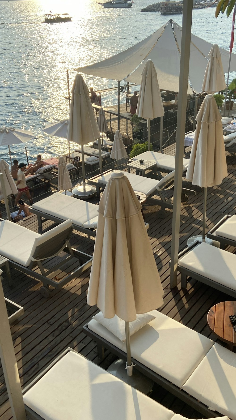 a group of lounge chairs sitting on top of a wooden deck