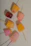 Close-up of colorful gourmet ice pops arranged on a rustic wooden table.