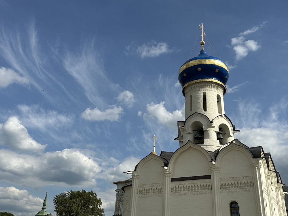 a large white church with a blue dome