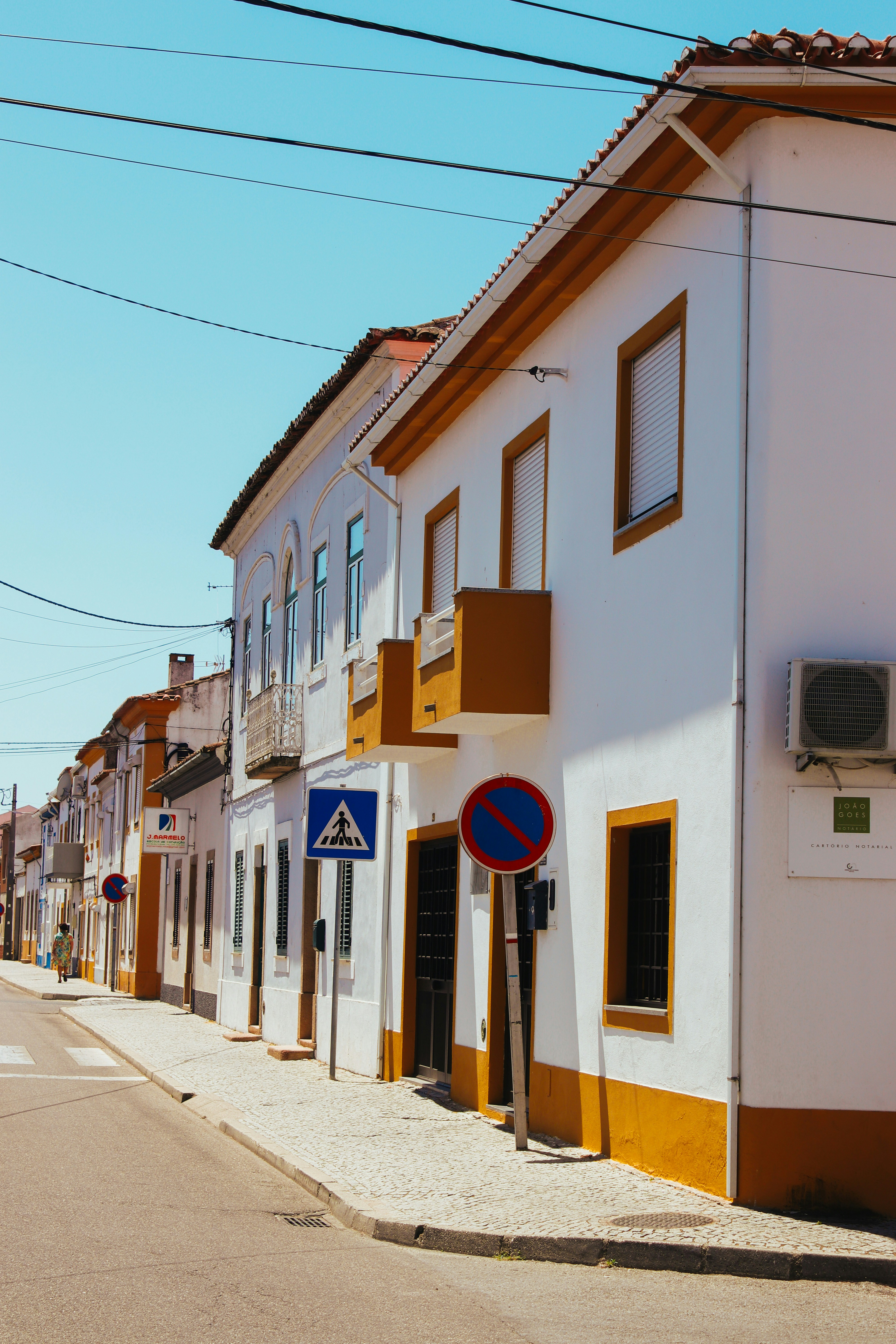 a white building with a blue sign on the side of it