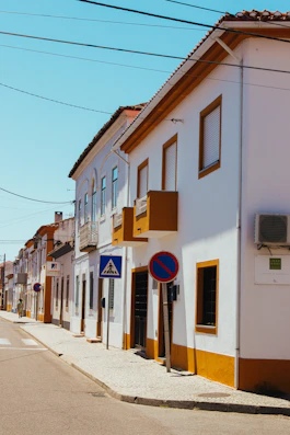 a white building with a blue sign on the side of it