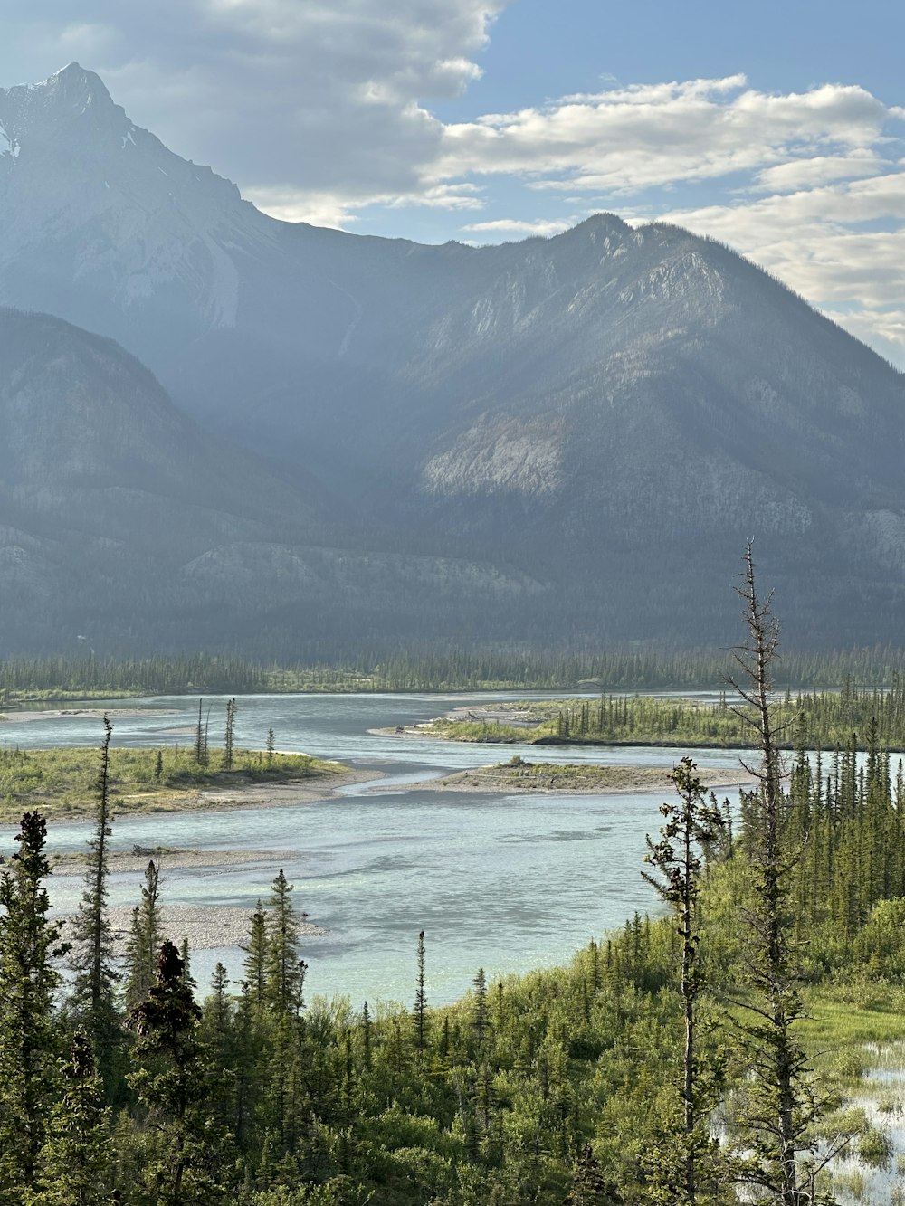 a view of a mountain range with a river in the foreground