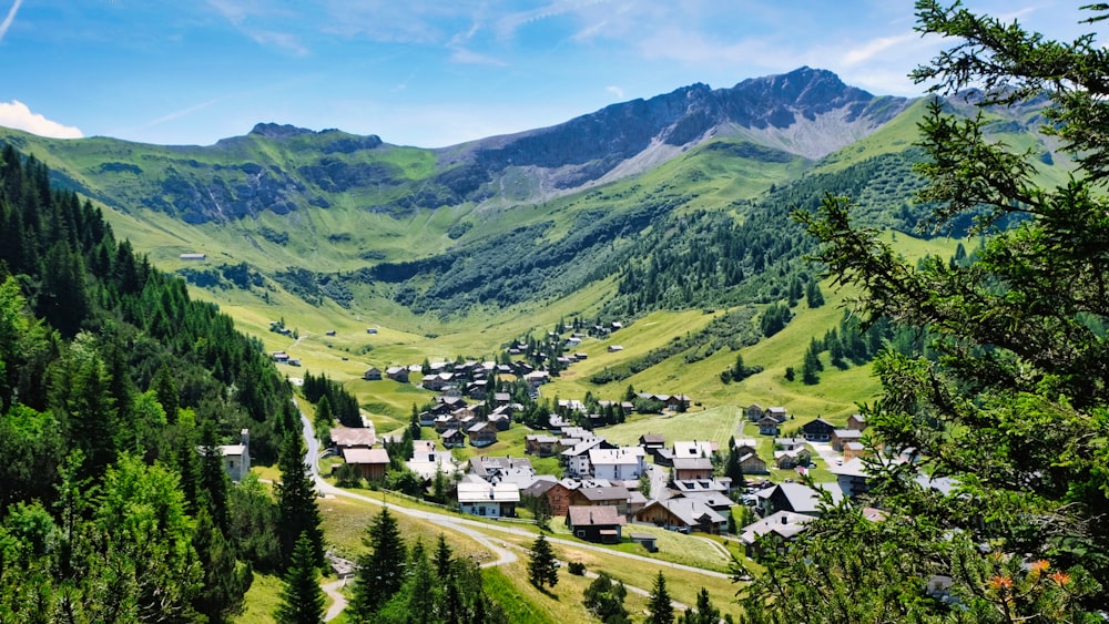 a village nestled in a valley surrounded by mountains