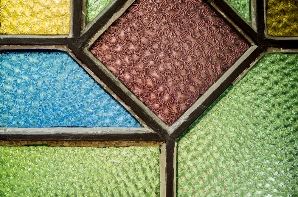 a close up of a multicolored stained glass window