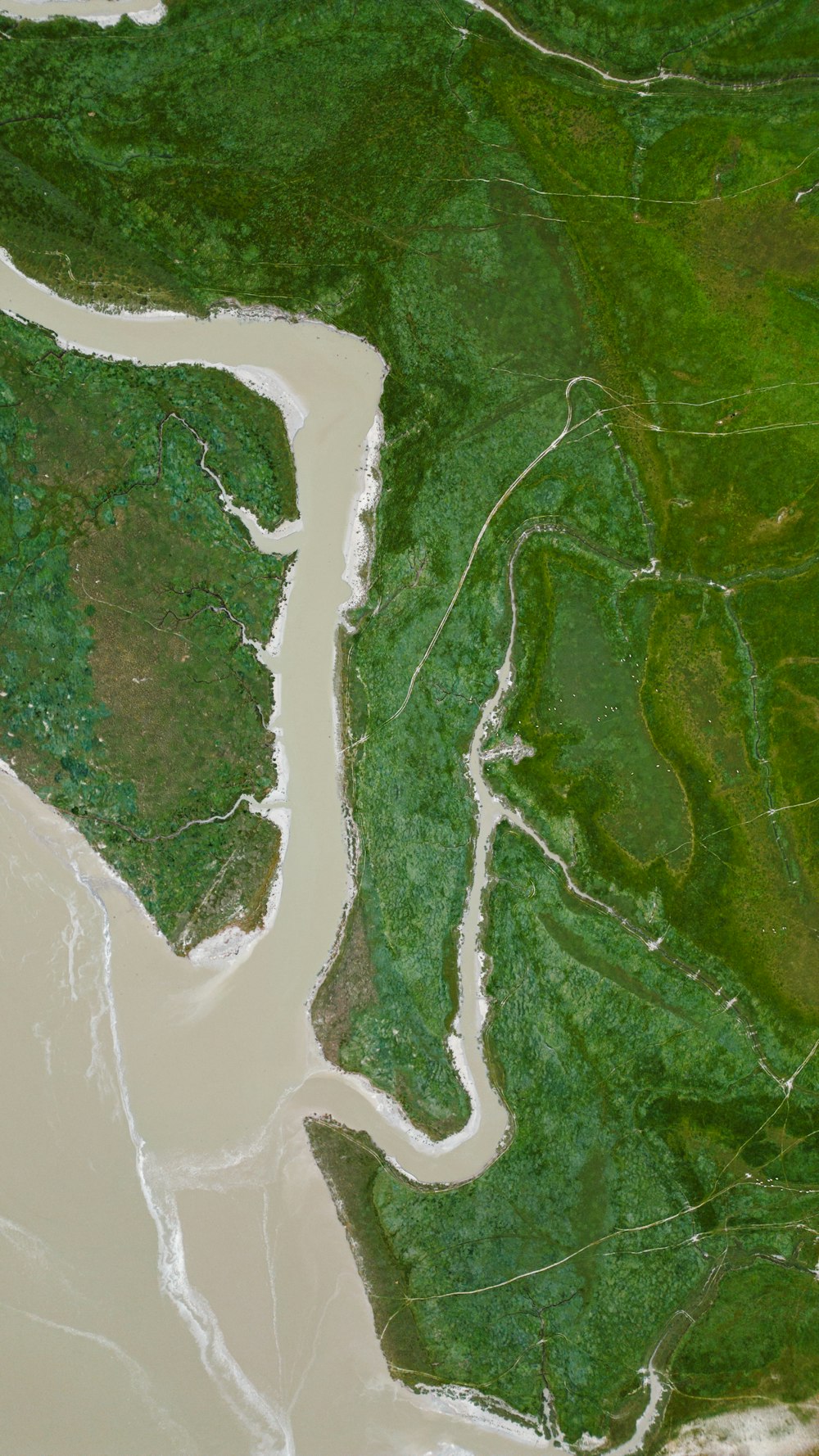 an aerial view of a body of water and land