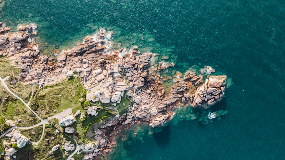 an aerial view of a rocky coastline and a body of water