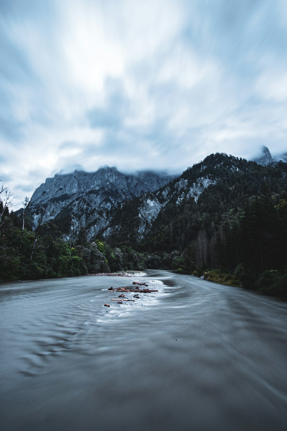 a body of water with mountains in the background