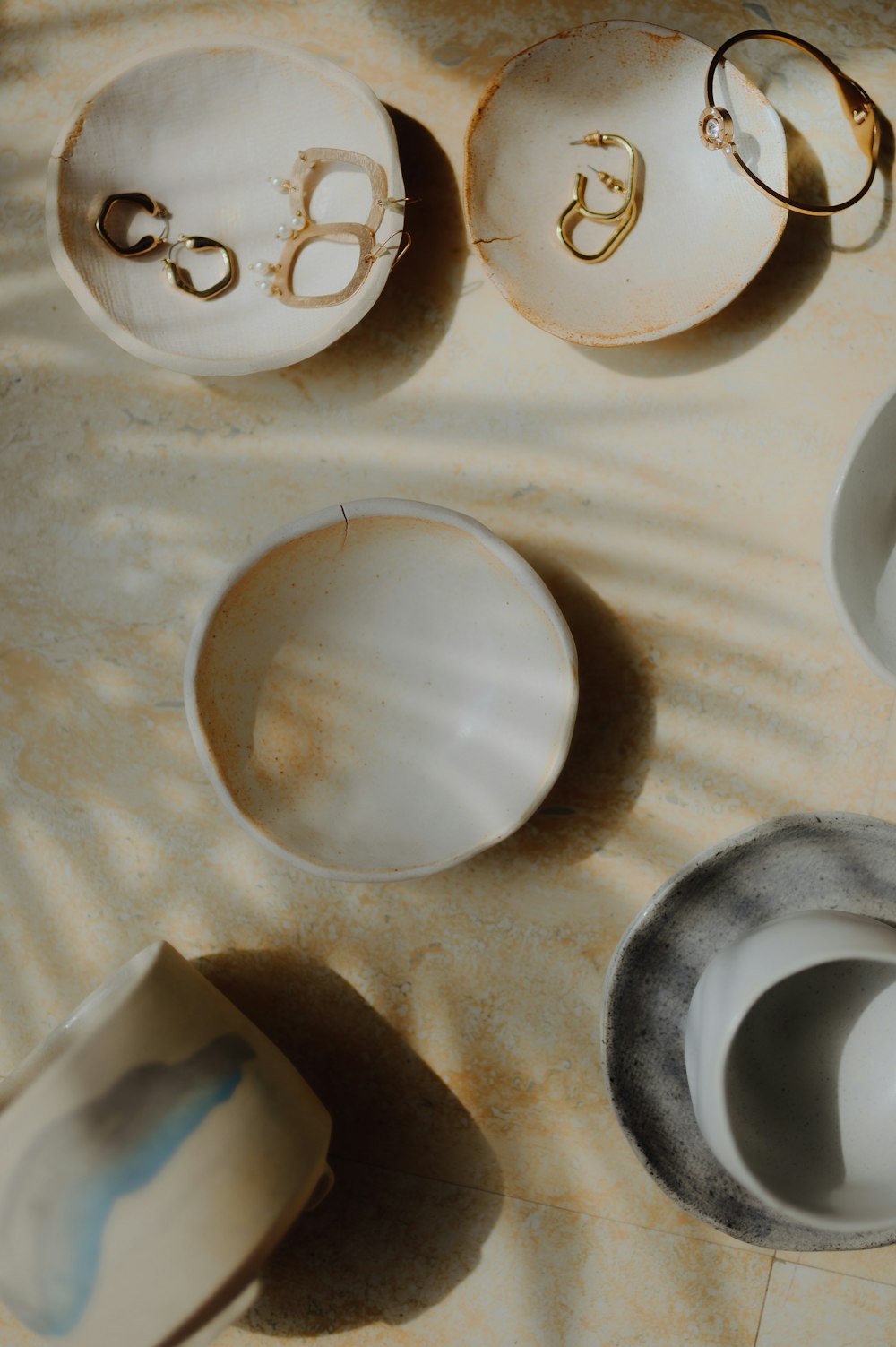 a table topped with white dishes and bowls