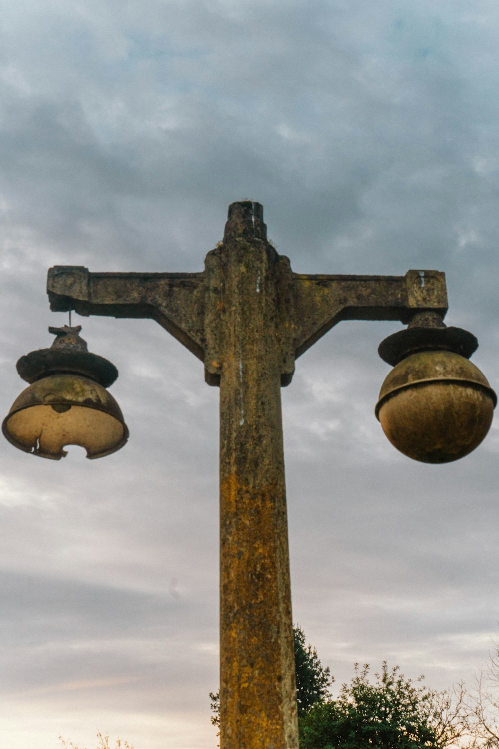 a wooden cross with three lights hanging from it