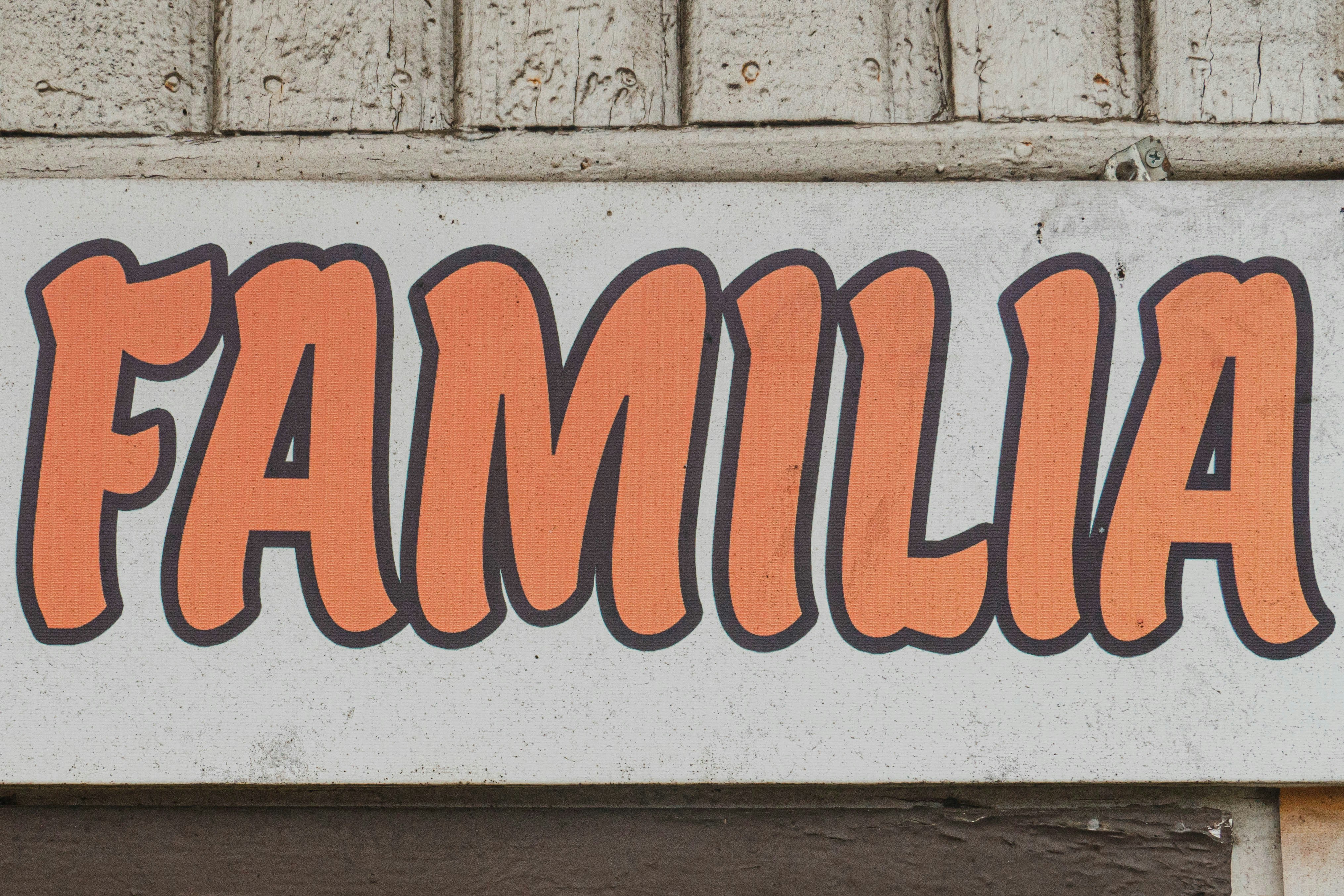 a white sign with orange writing on it