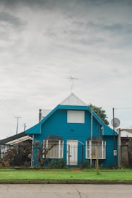 A cozy family home with a blue sky background symbolizing security.