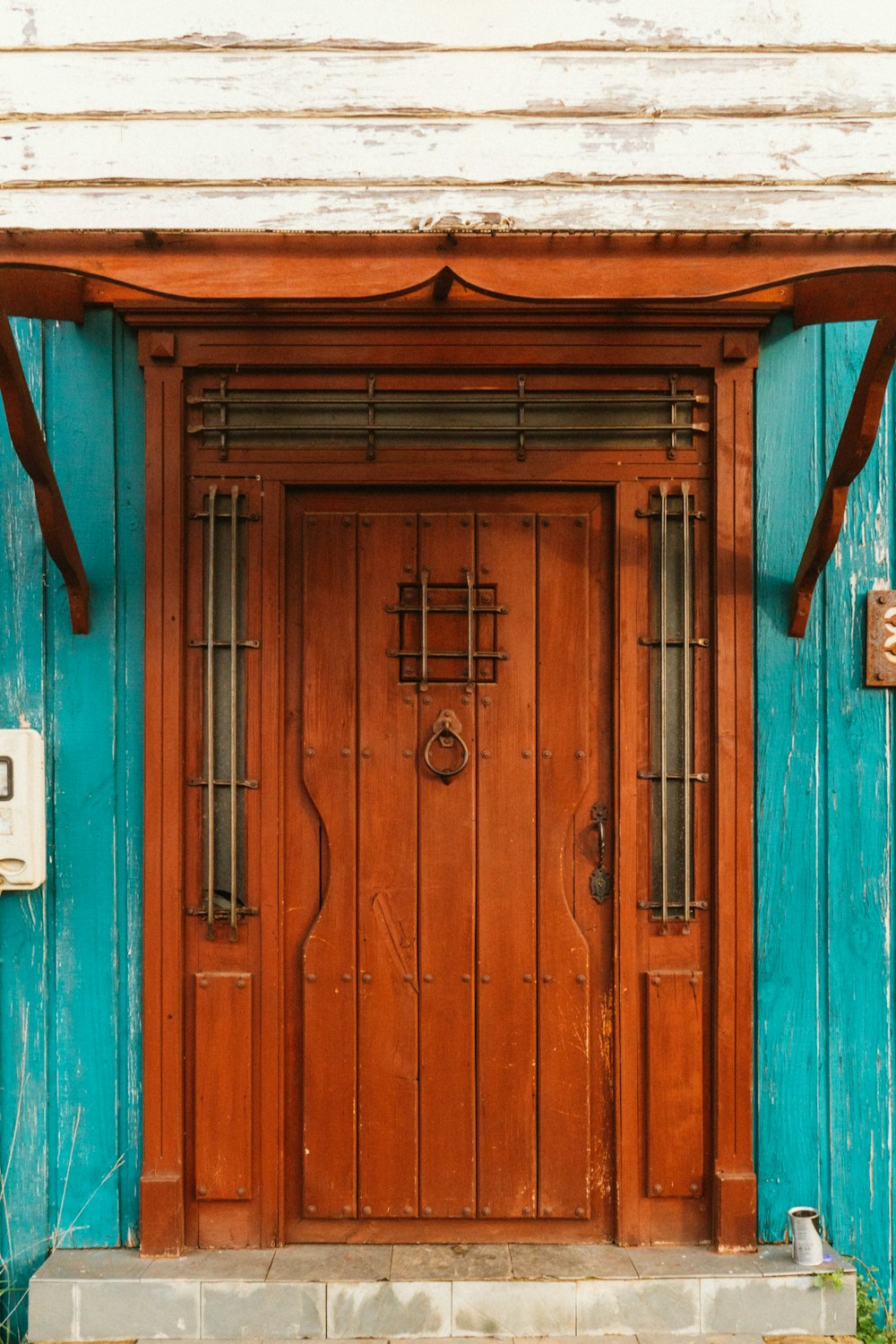 a wooden door on a blue building