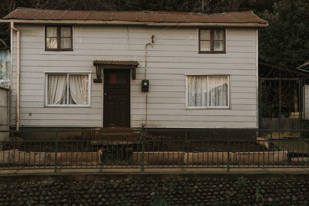 a white house with a black door and window