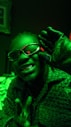 a man in a dark room wearing glasses