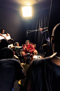 a group of people sitting in a dark room