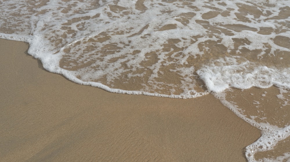 a close up of a wave on a beach