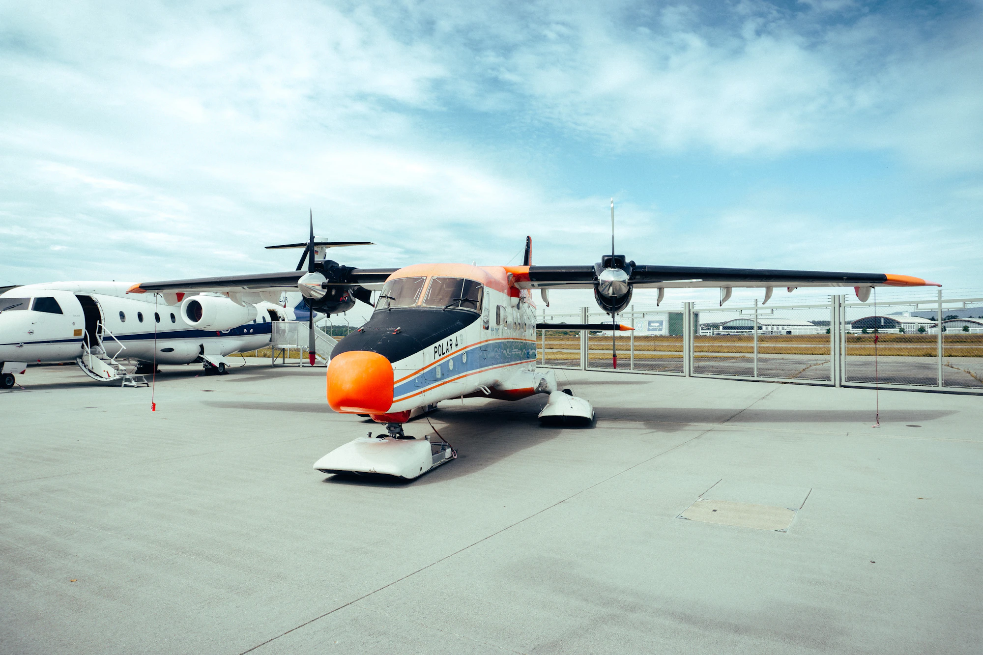 Small propeller plane parked on a regional airport tarmac
