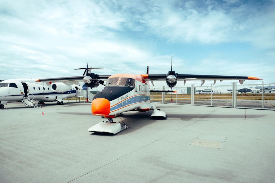 a small plane sitting on top of an airport tarmac,