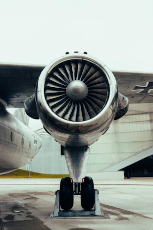 Technicians performing detailed maintenance on an aircraft engine.