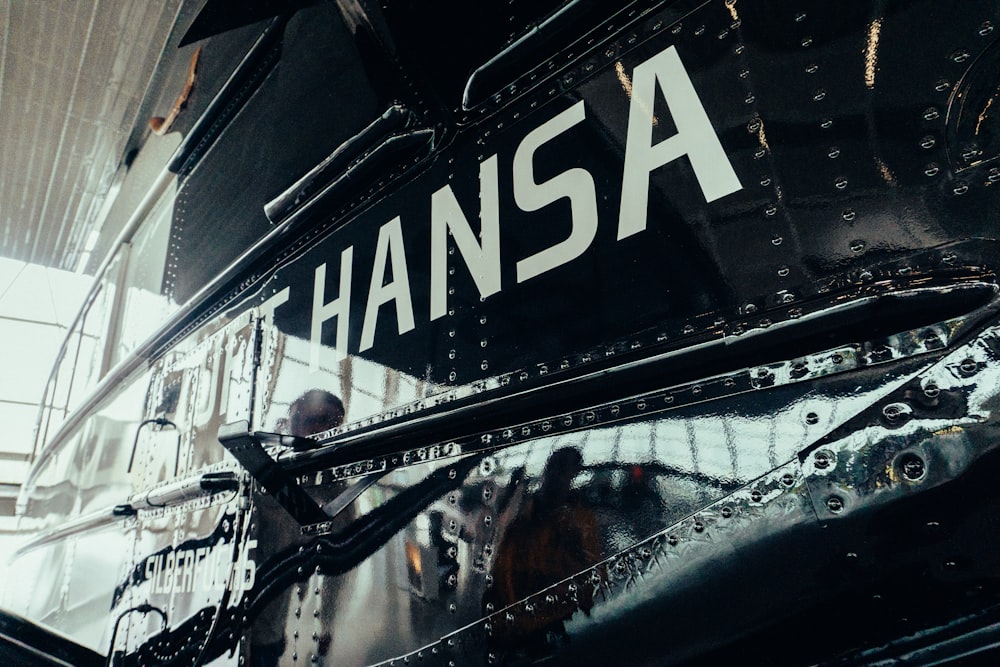 a close up of the side of a black airplane