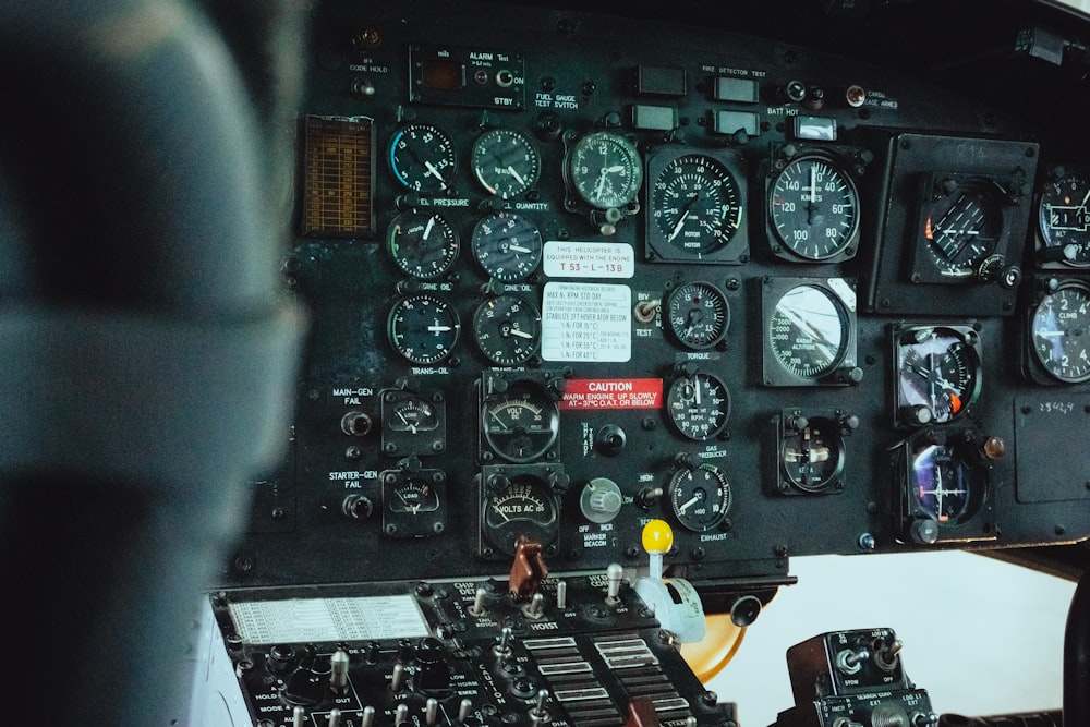 the cockpit of an airplane with many gauges and dials
