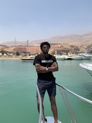 A confident family standing beside their car at a sunny marina, symbolizing protection across land and sea.