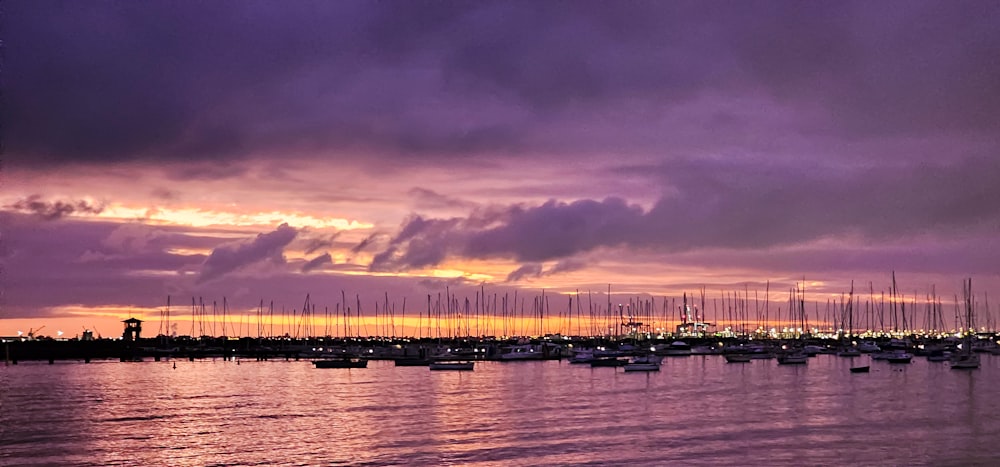 a harbor filled with lots of boats under a cloudy sky