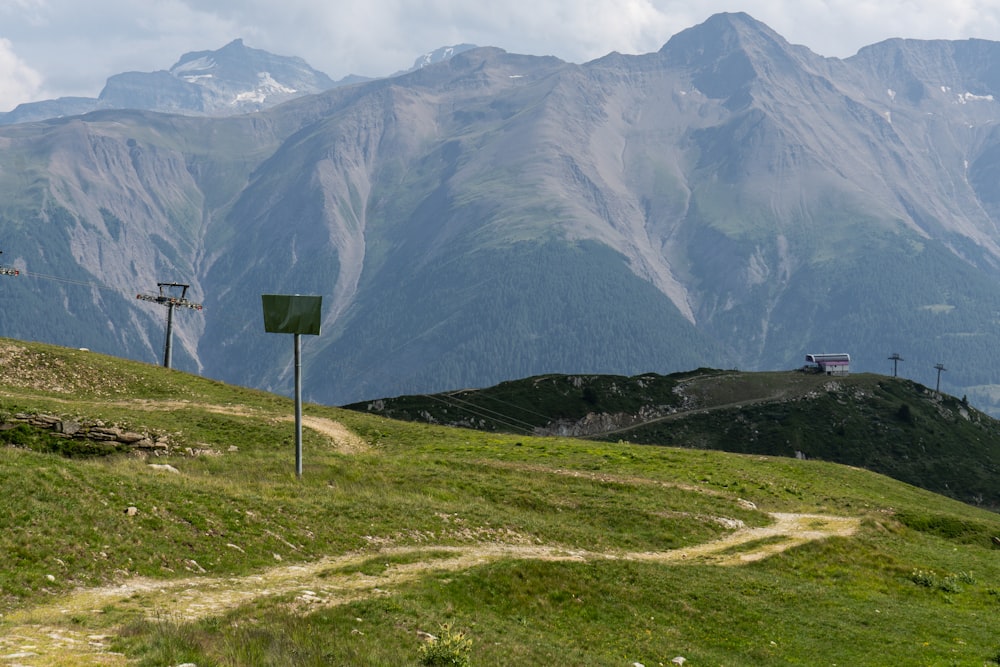 a grassy hill with a sign on the side of it