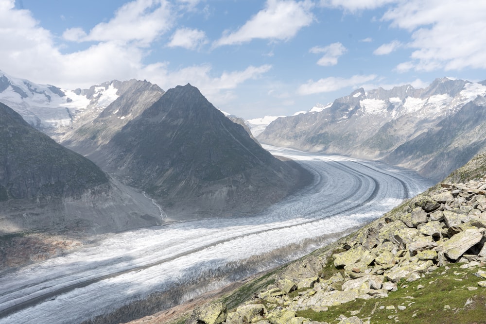 a man standing on top of a mountain next to a glacier