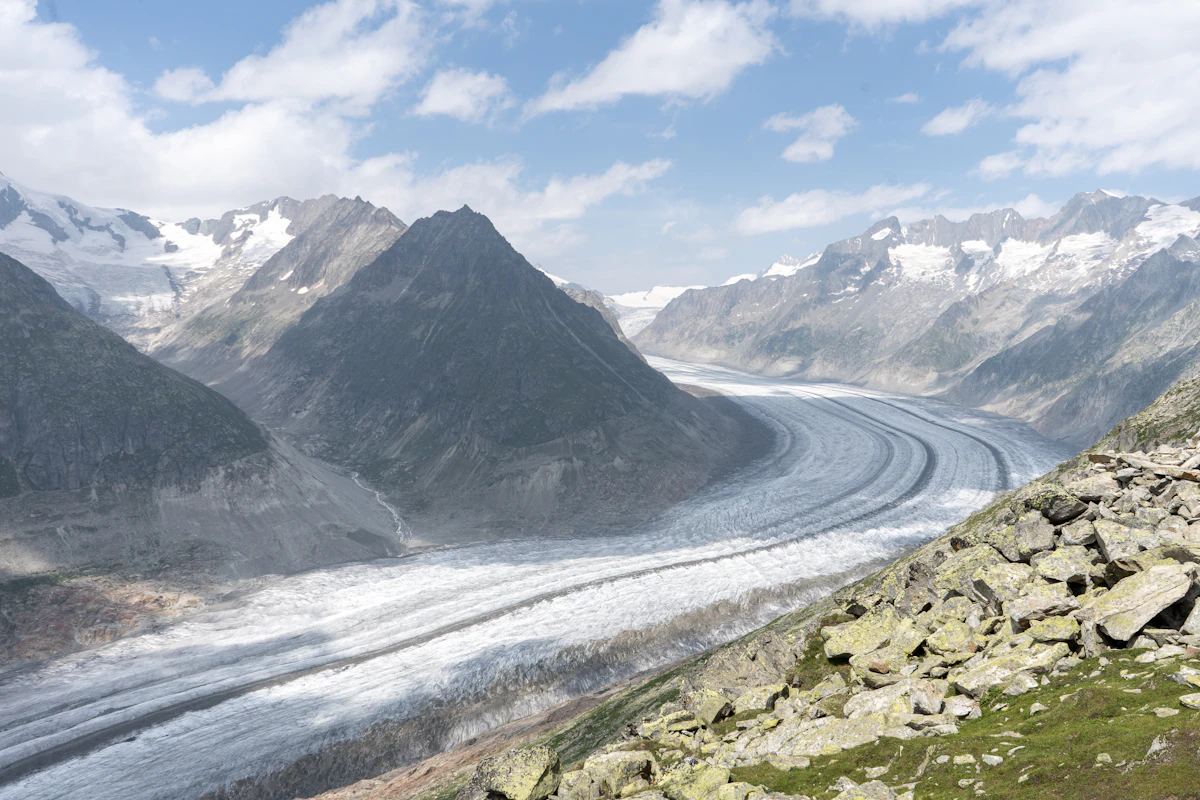 Long alpine glacier winding between high peaks