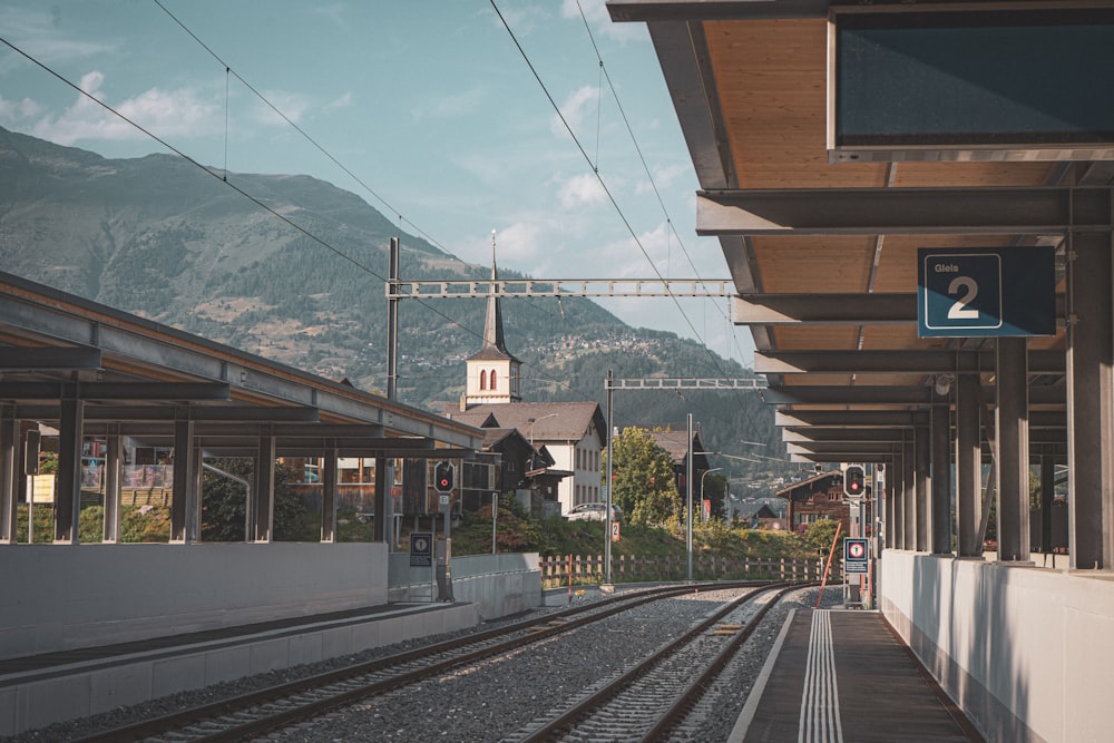 a train station with a clock tower in the background