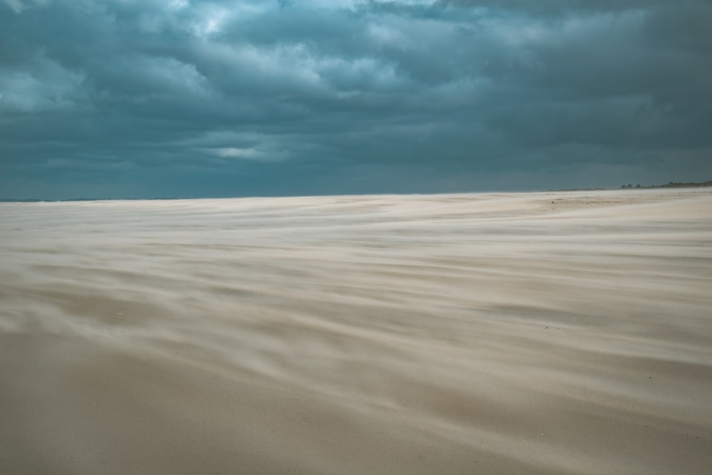 a sandy beach under a cloudy sky