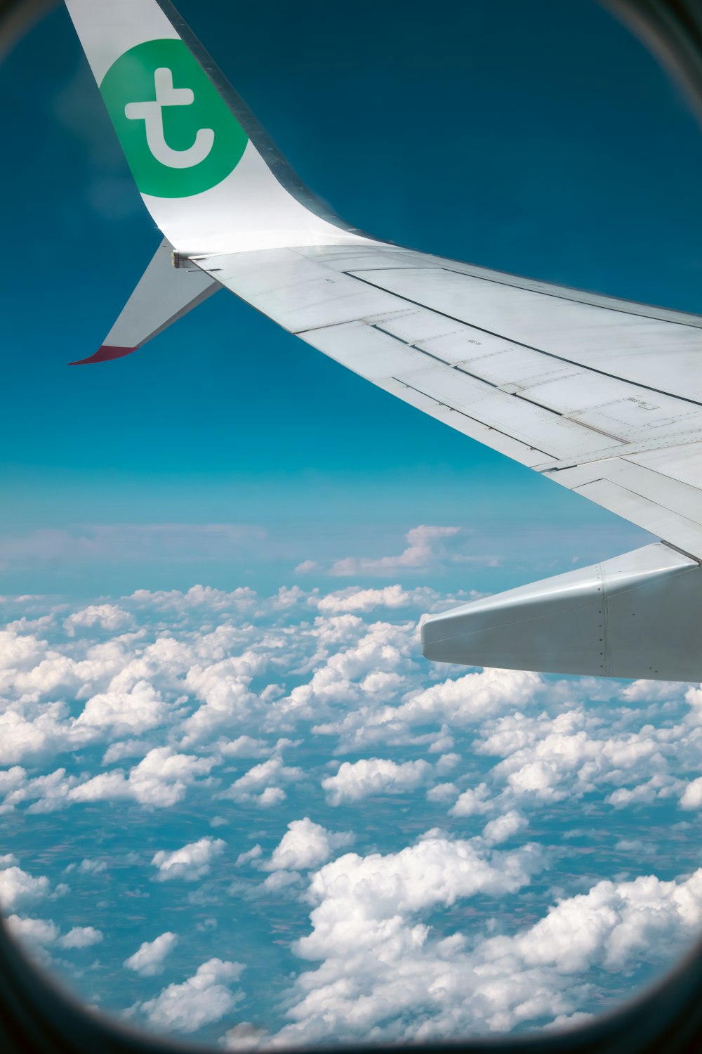 a view of the wing of an airplane in the sky