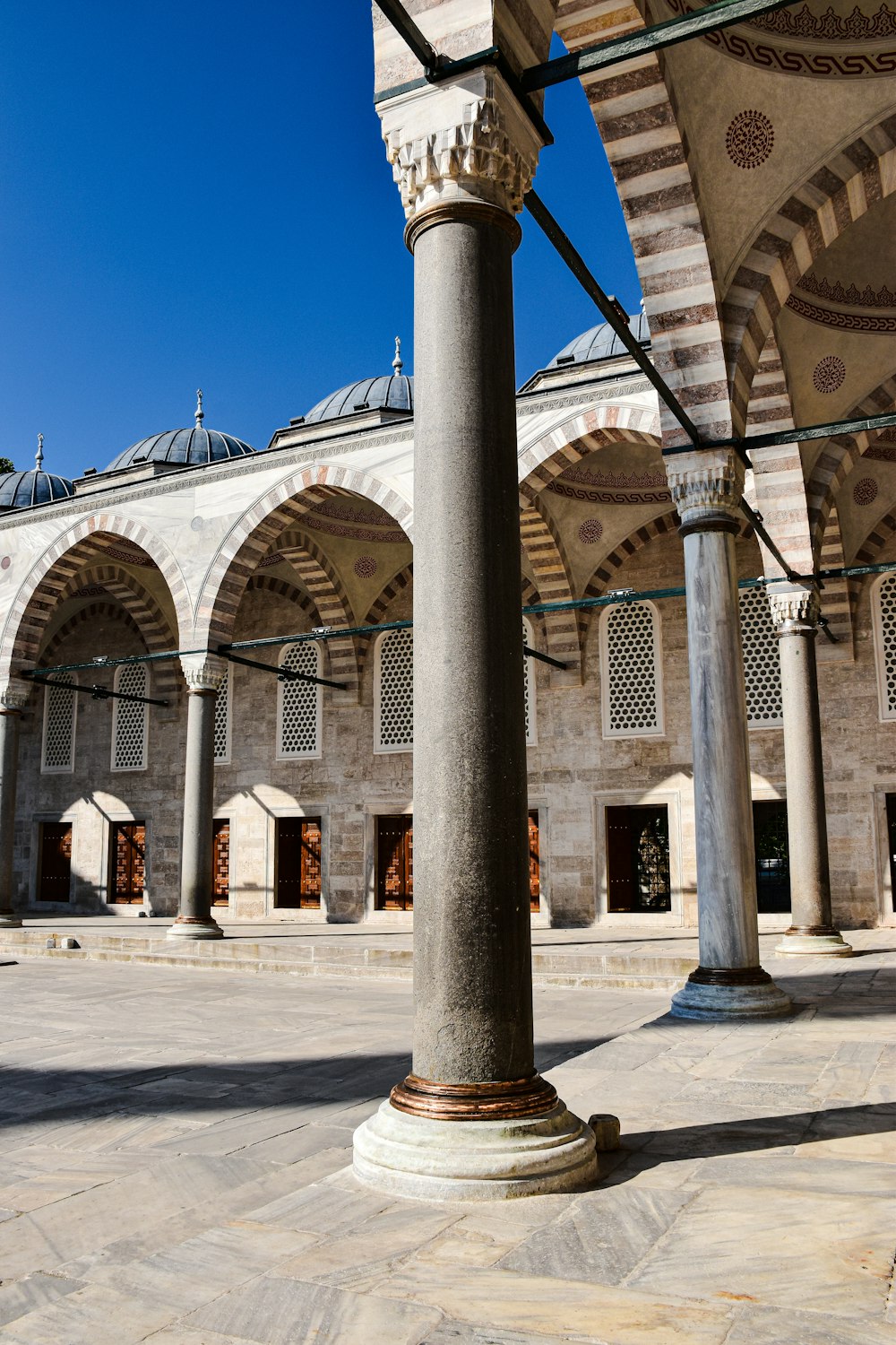 a large building with columns and arches in front of it