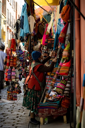 A vibrant street market scene showcasing colorful handcrafted goods from an artisan brand.