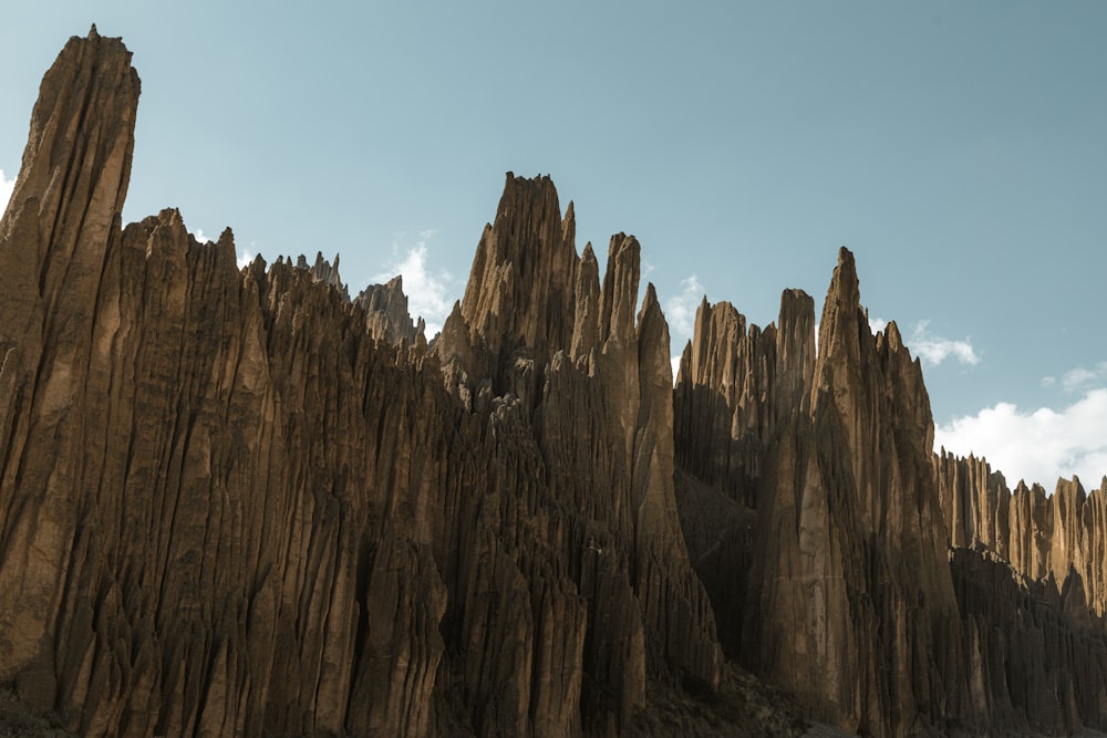 a large rock formation with a sky background