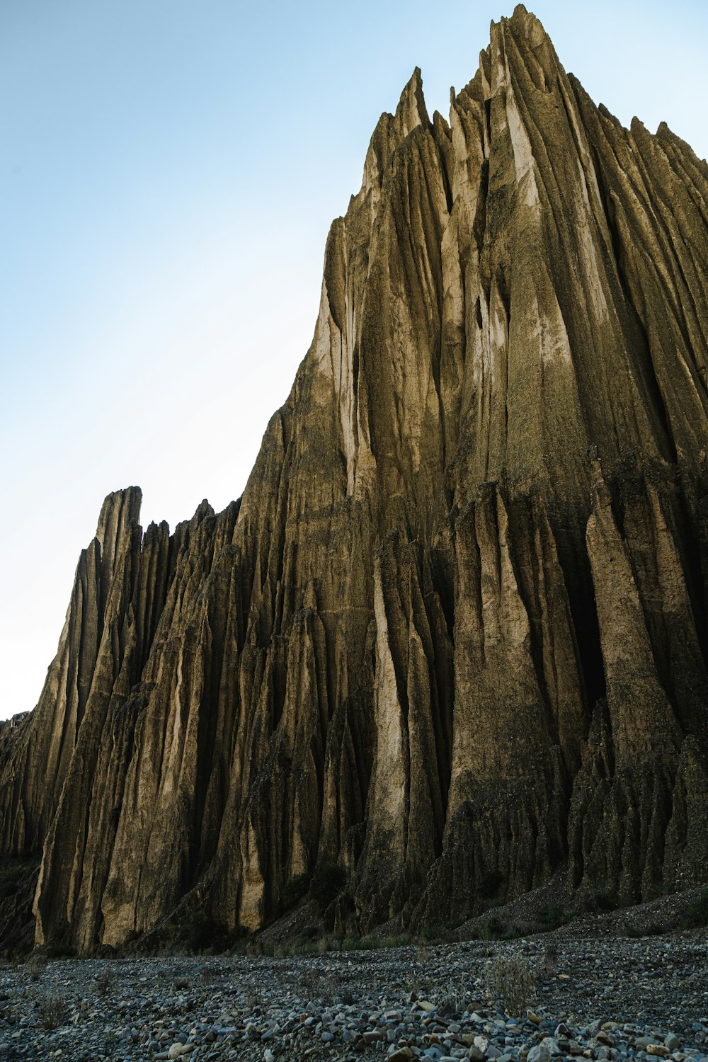 a very tall rock formation with a sky in the background
