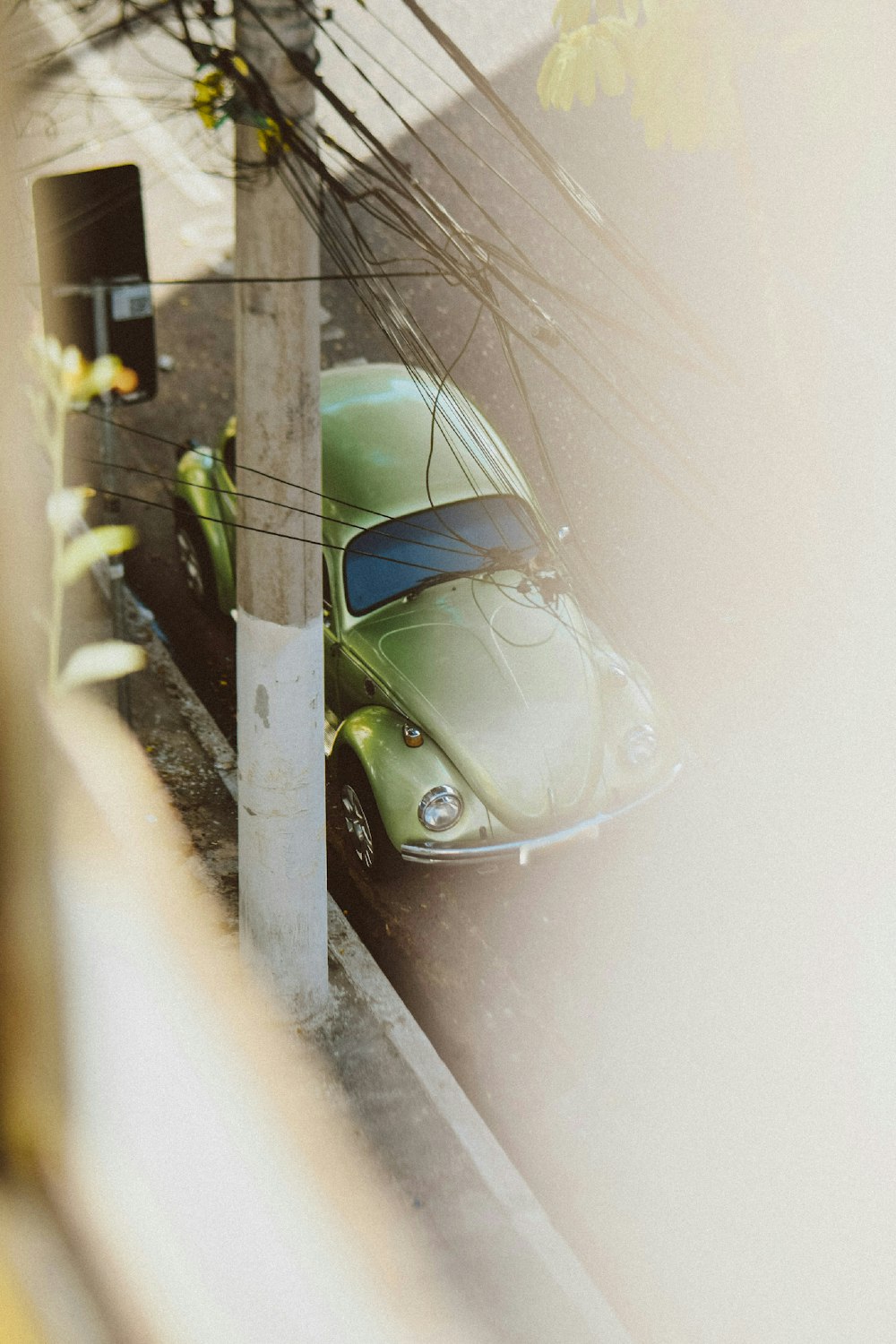 a green car parked on the side of the road