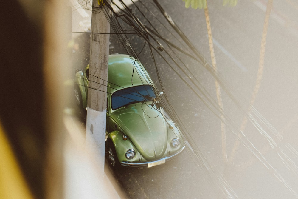 a green car parked on the side of a road