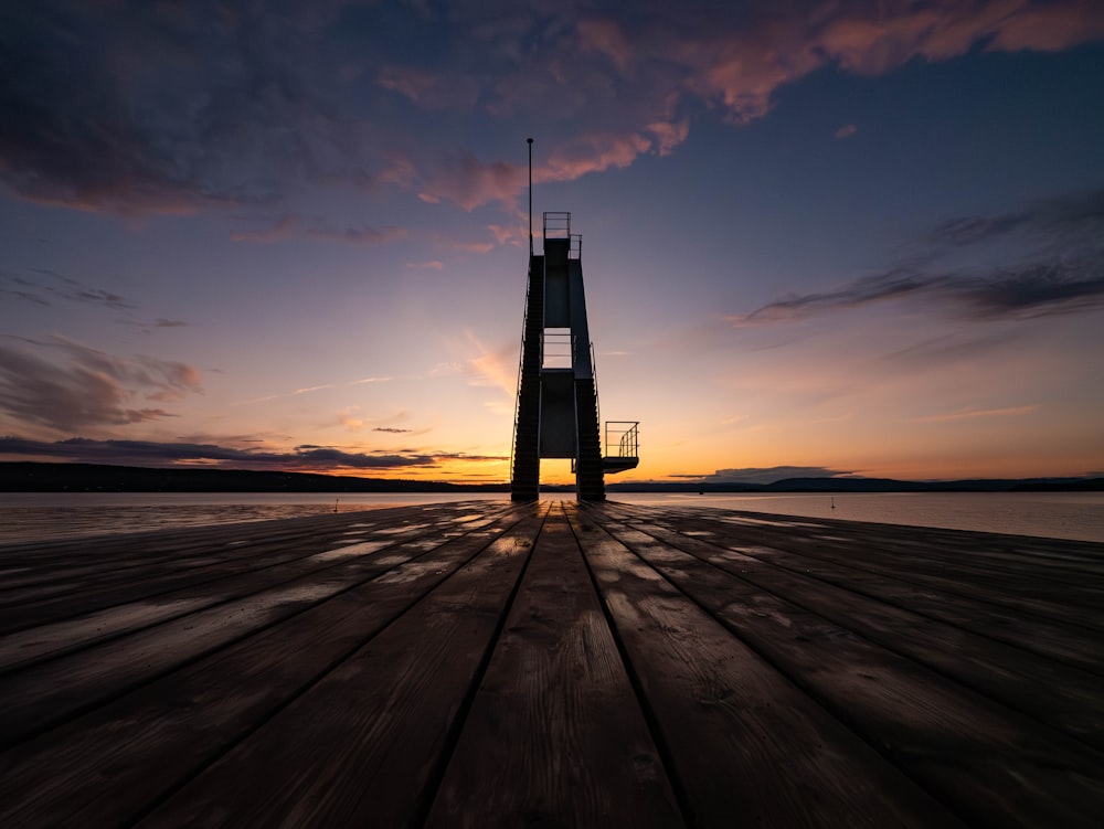 a tower sitting on top of a wooden pier