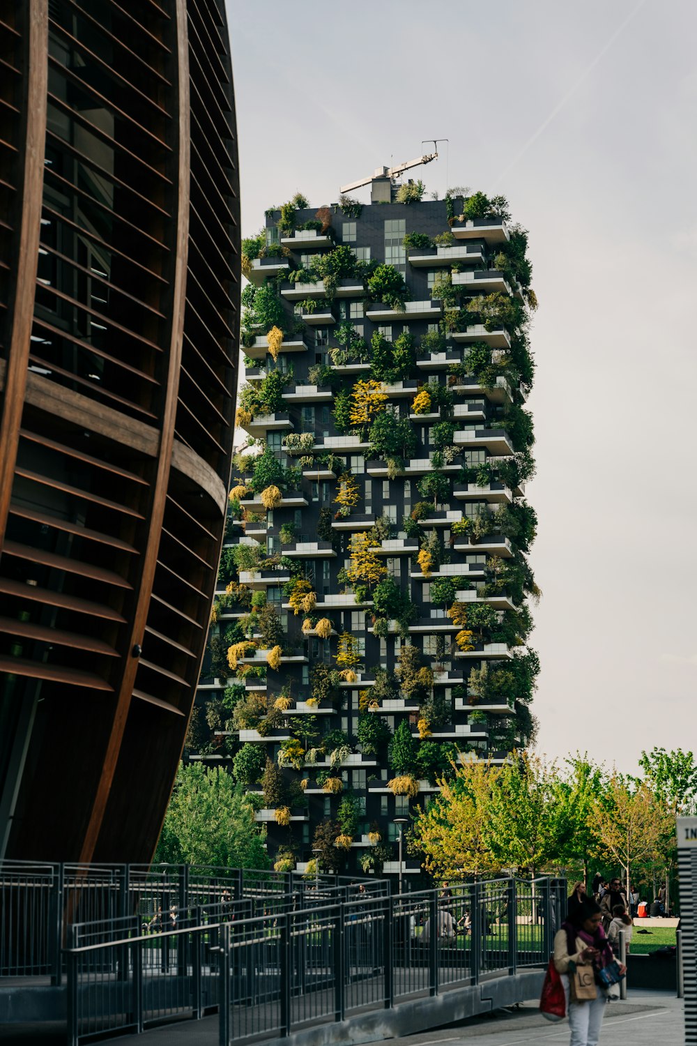 a very tall building with a lot of plants growing on it