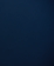 A serene, midnight navy backdrop highlighting subtle textures and sophisticated materials.