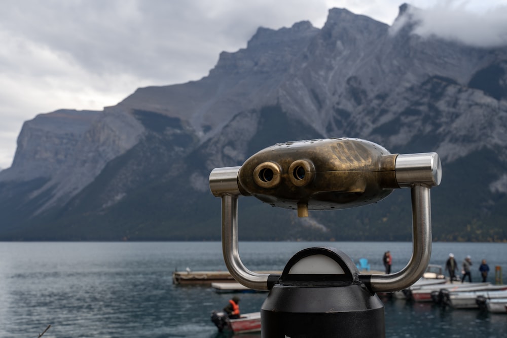 a close up of a telescope near a body of water