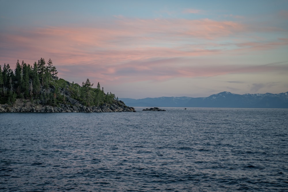 a large body of water with a small island in the middle of it