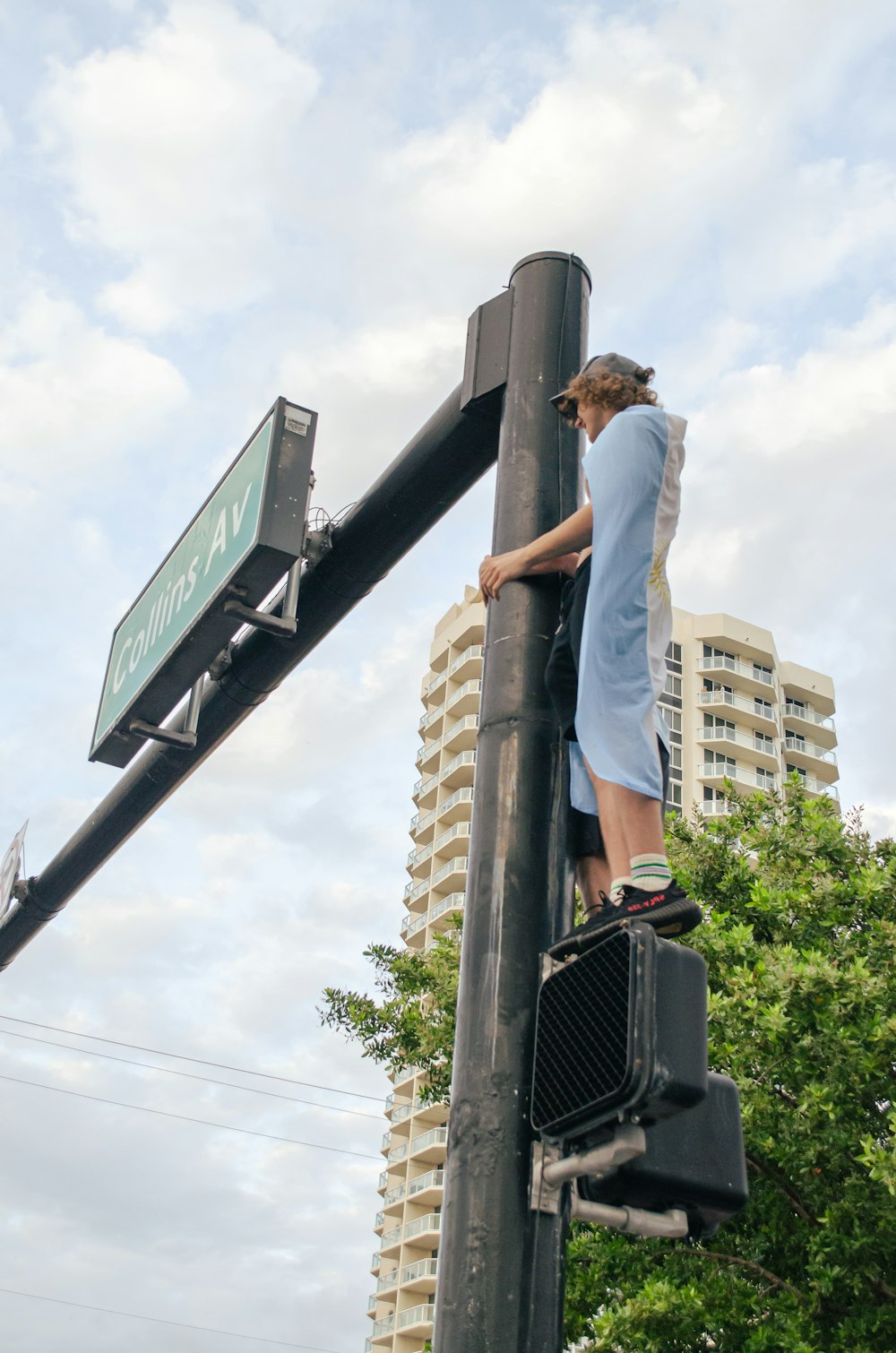 a man standing on top of a traffic light