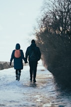 A senior couple walking with walkers near a famous Canadian landmark covered in snow.