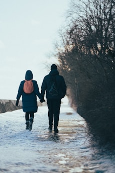 A senior couple walking with walkers near a famous Canadian landmark covered in snow.